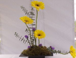 The bright pop of yellow sunflowers with a touch of purple show subtle beauty.