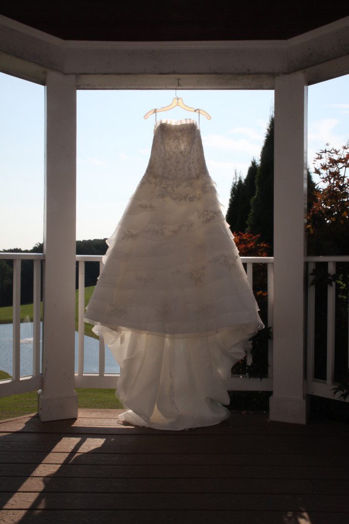 The wedding dress hangs in the inside wedding area and is highlighted by the sun. This area is used as an alternative ceremony location if weather prohibits an outside wedding ceremony.
