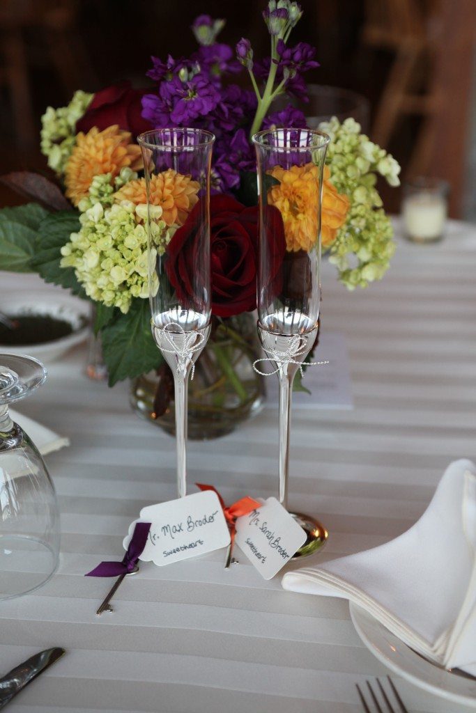 head table with bride and groom champagne flutes