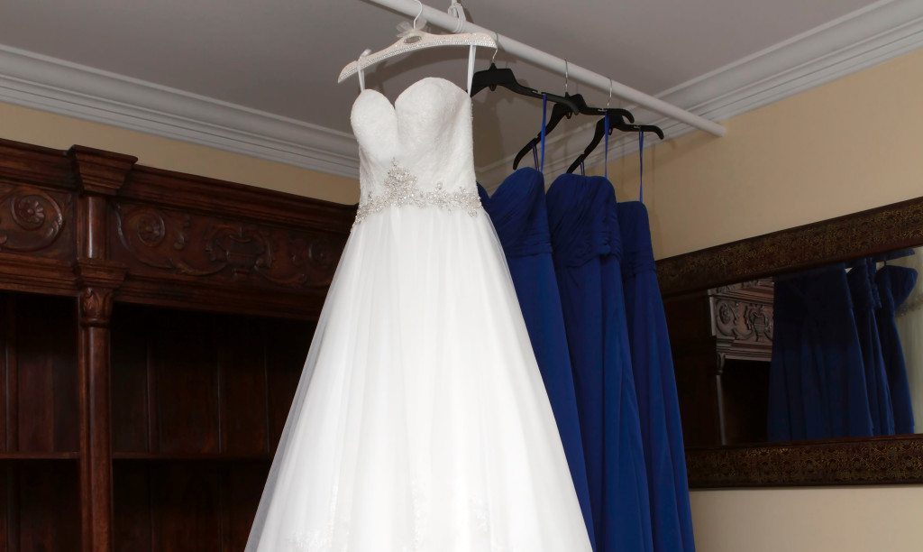 Bride's wedding dress hangs in the brides room at Morningside Inn wedding ceremony site