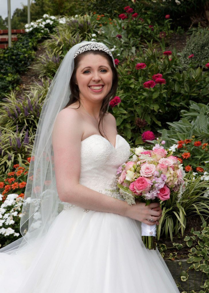 Bride in garden before summer wedding