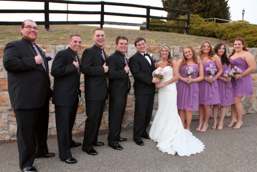bridal party in front of stone wall at morningside inn outdoor wedding venue located in frederick maryland
