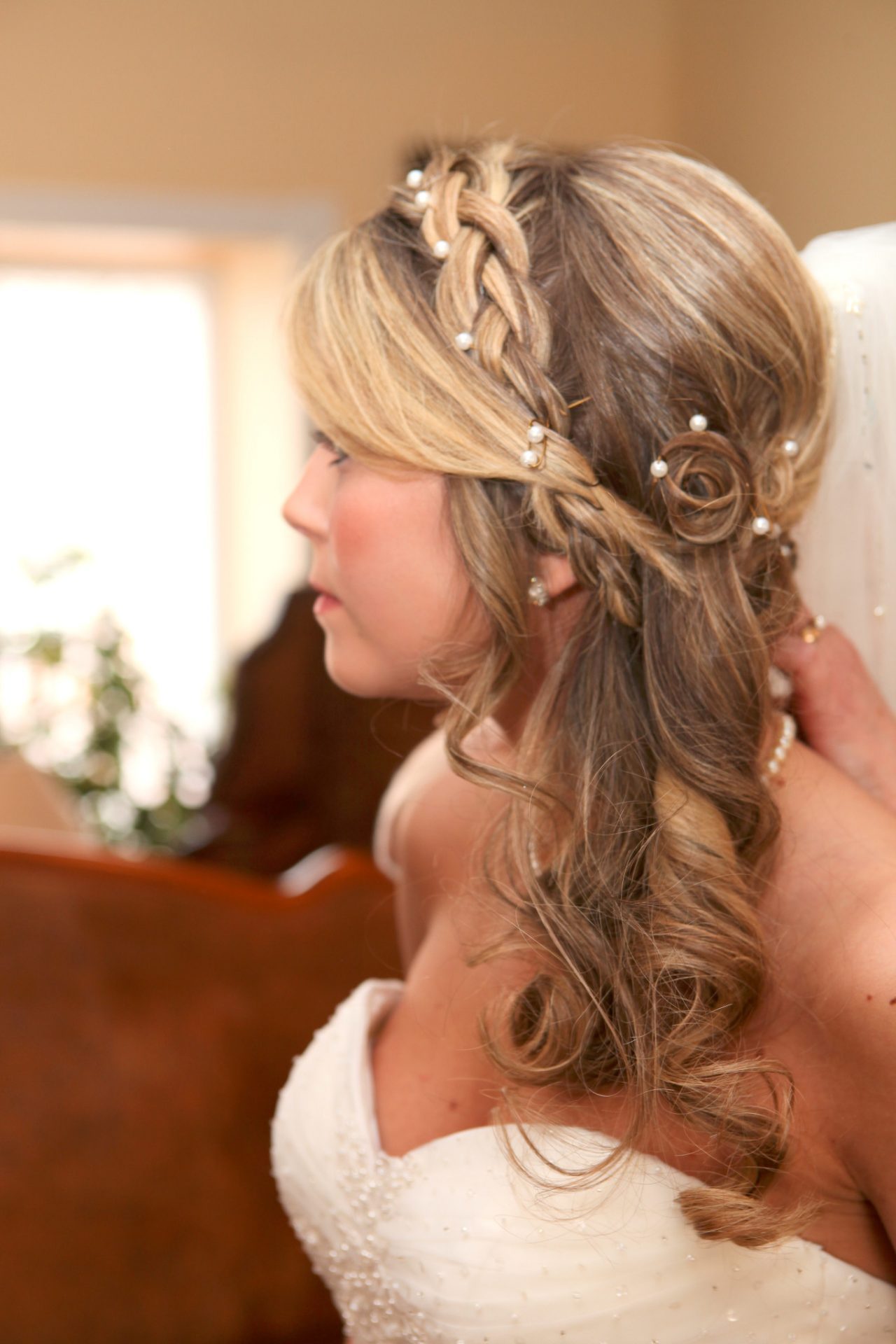 Bride's hair style with light curls and braids