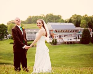 Bride and groom posing in the field behind Morningside Inn after their spring wedding in Frederick, Maryland