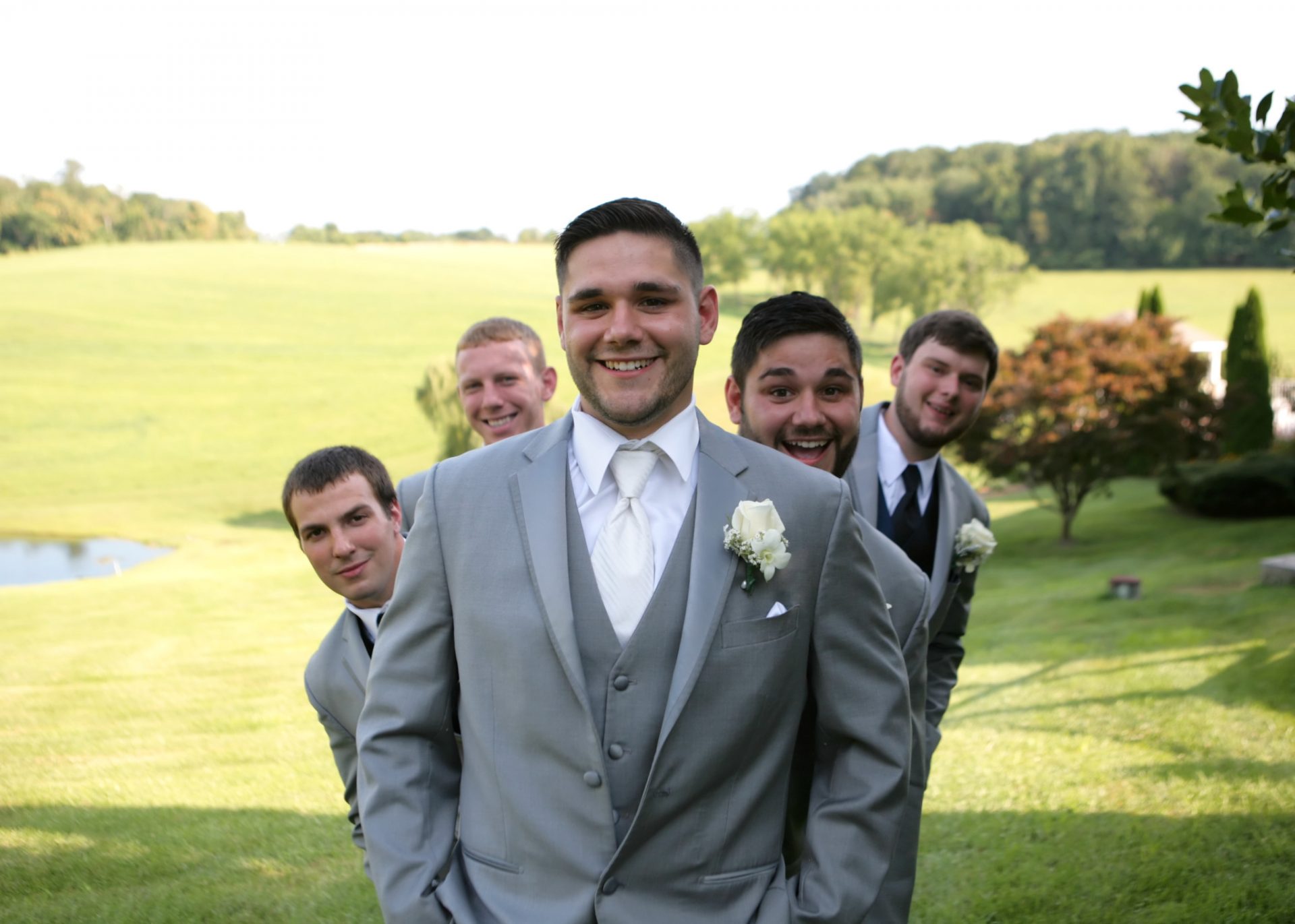 groomsmen on the back lawn during spring wedding in Maryland