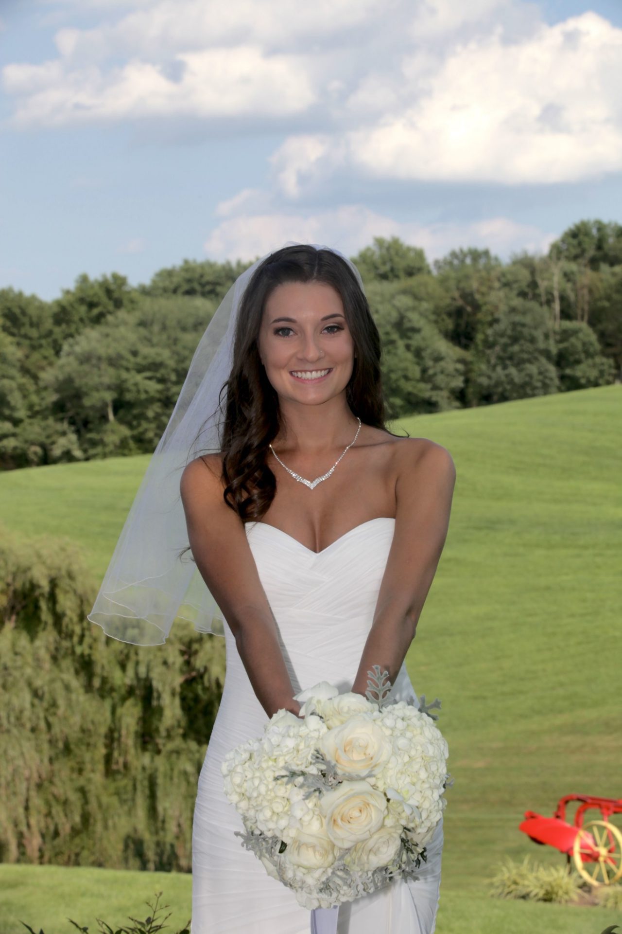 Bride posing on deck on the side of Morningside Inn before her spring wedding in Maryland