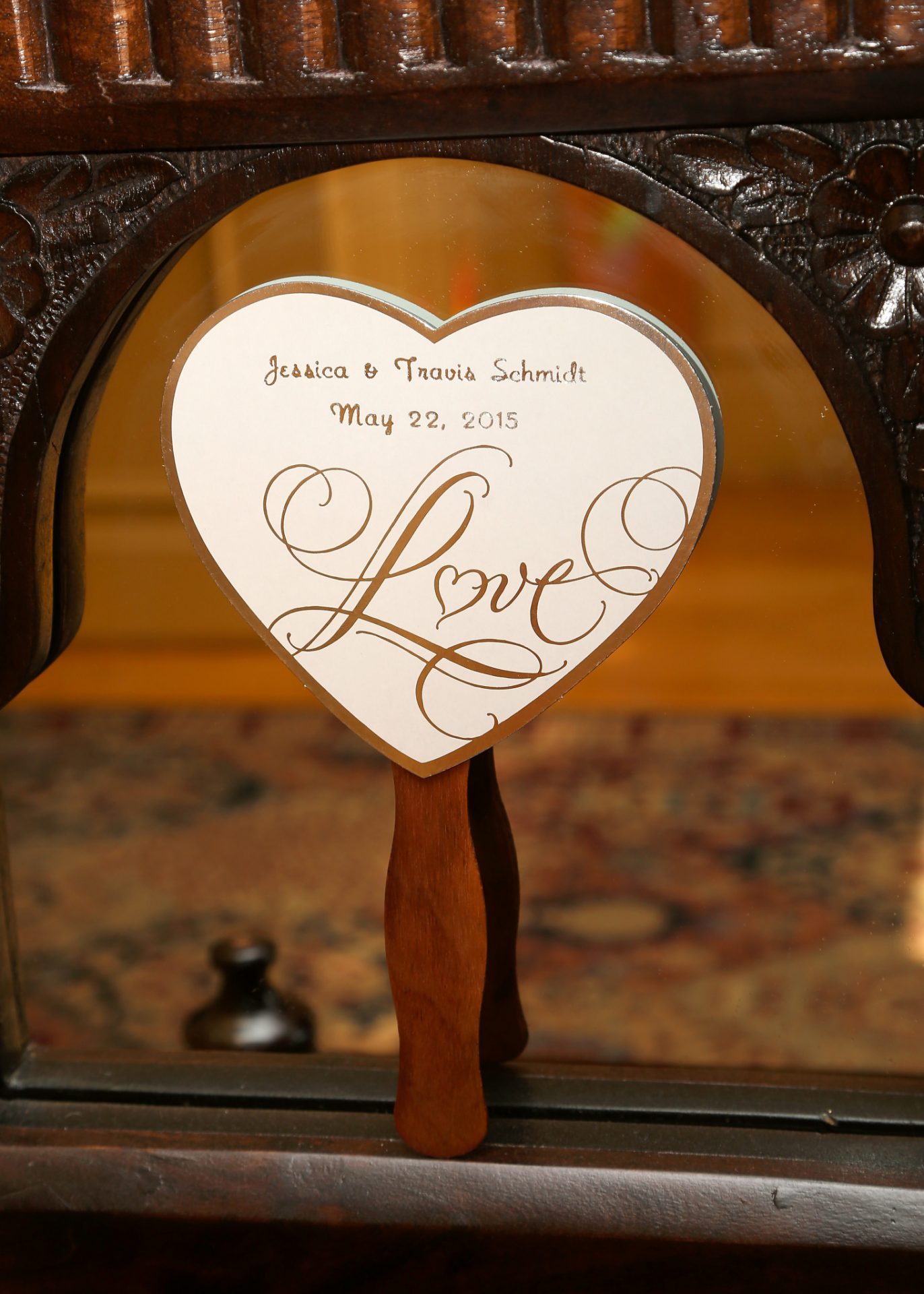heart shaped fan used during outside wedding ceremony