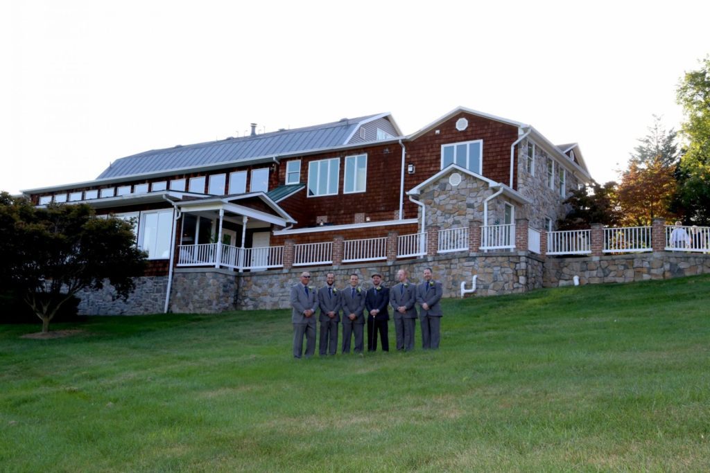 At Maryland wedding venue Groomsmen line up on lawn outside of groom's room at country wedding venue in Frederick Maryland
