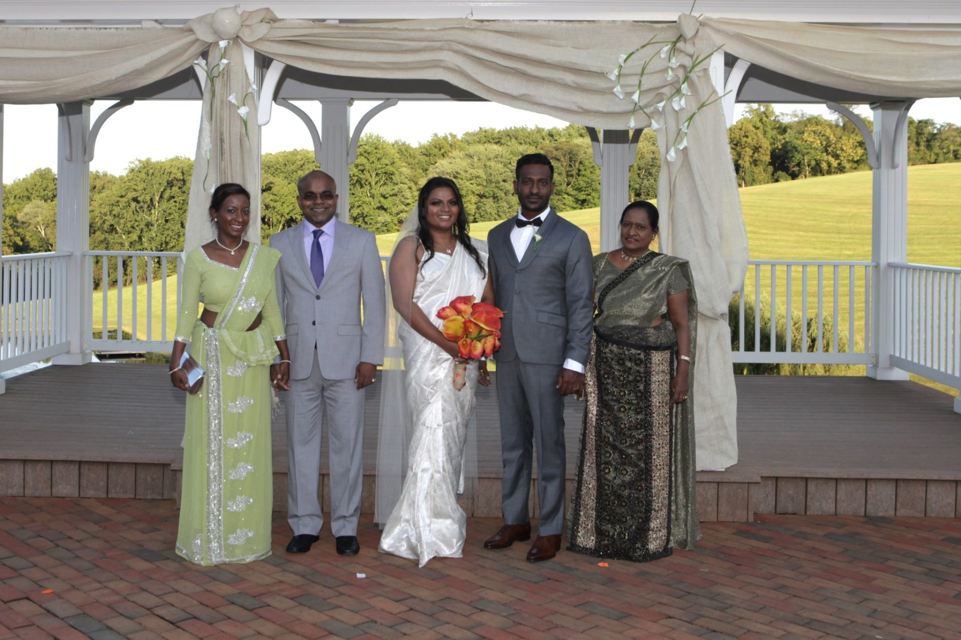 Family photograph in front of wedding pavilion