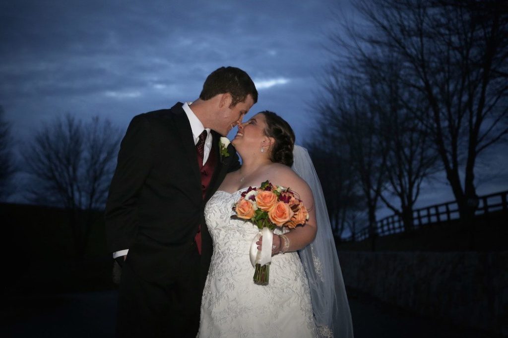 Bride and groom share a kiss outside of Morningside Inn after wedding