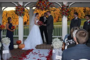 fall wedding venue in maryland, Morningside Inn provides awesome autumn wedding colors for photographs. Bride and groom on altar at their outdoor fall wedding ceremony