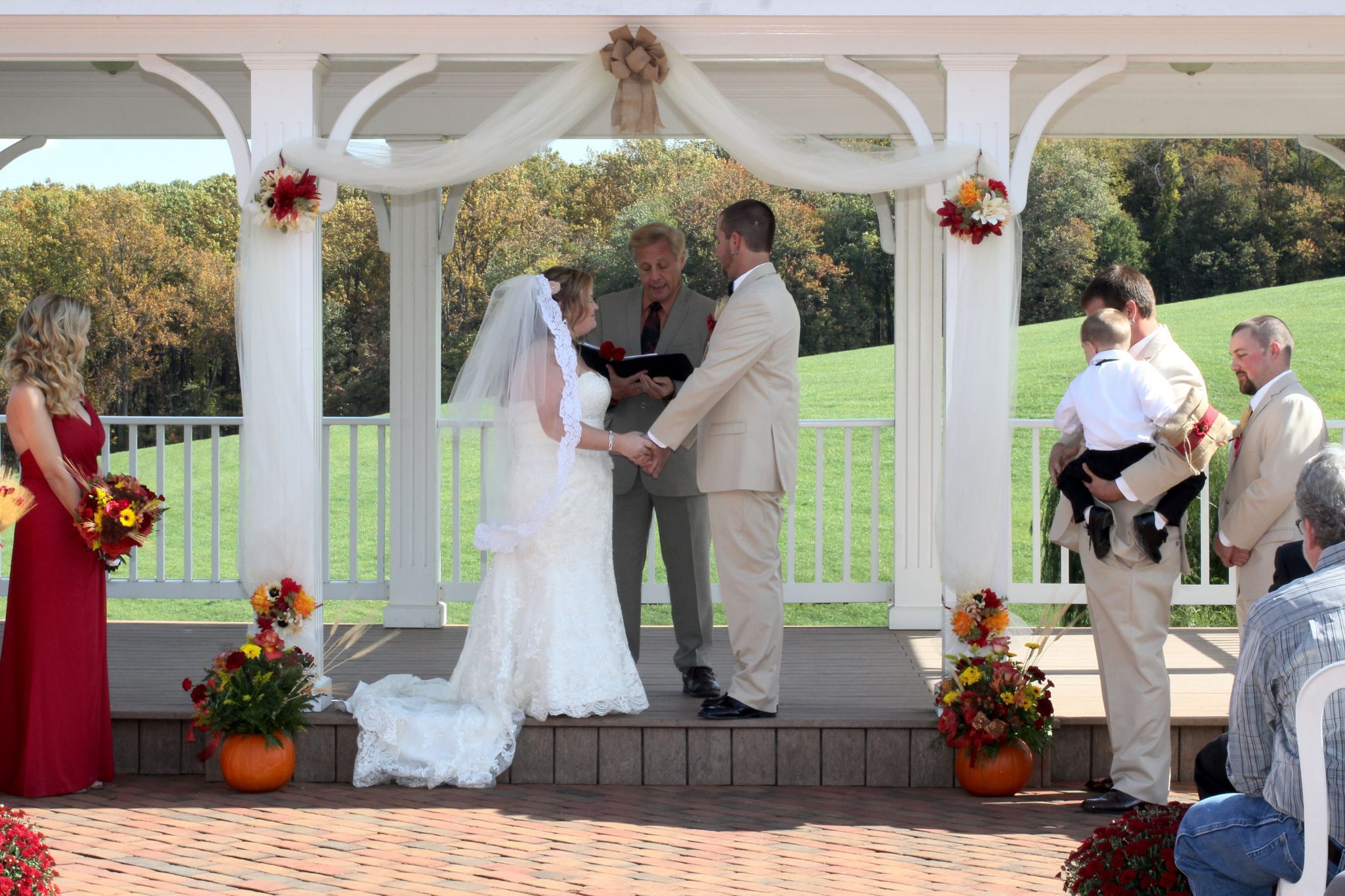 The couple exchange vows on the outdoor pavilion on a gorgeous fall day