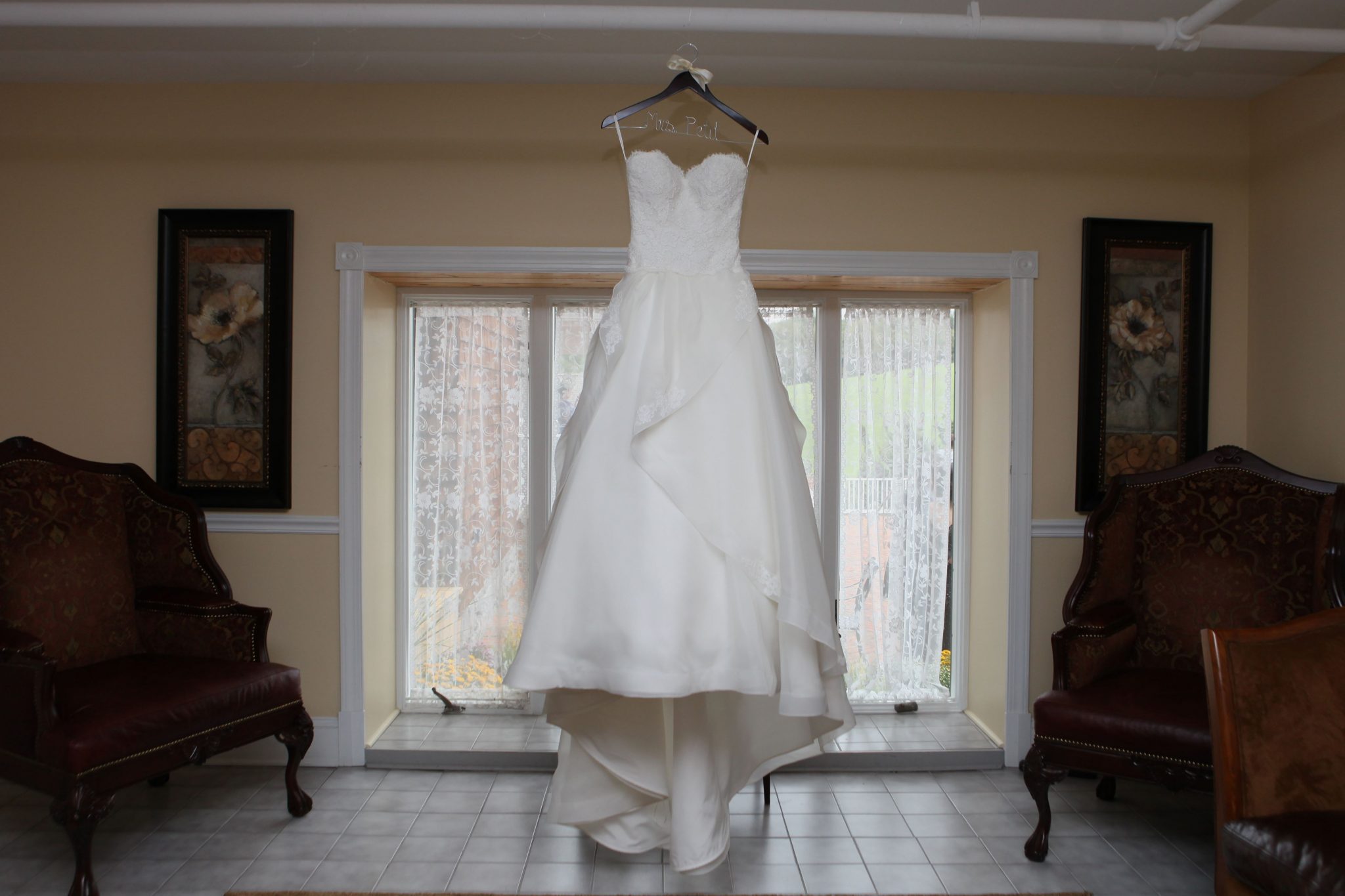 Bride's dress hangs in the bride's room before the wedding ceremony.