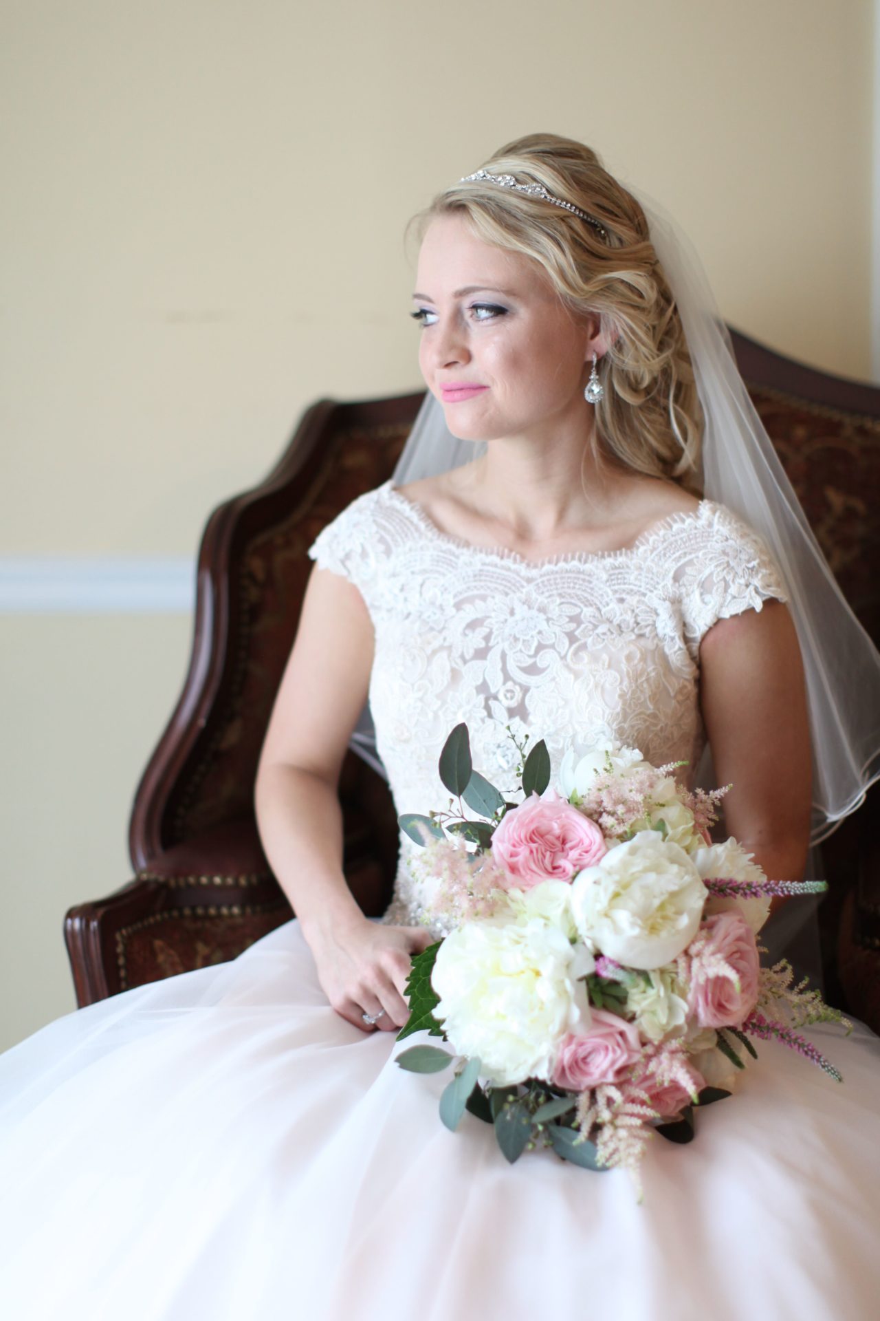 Bride poses in victorian chair in brides room at Morningside Inn