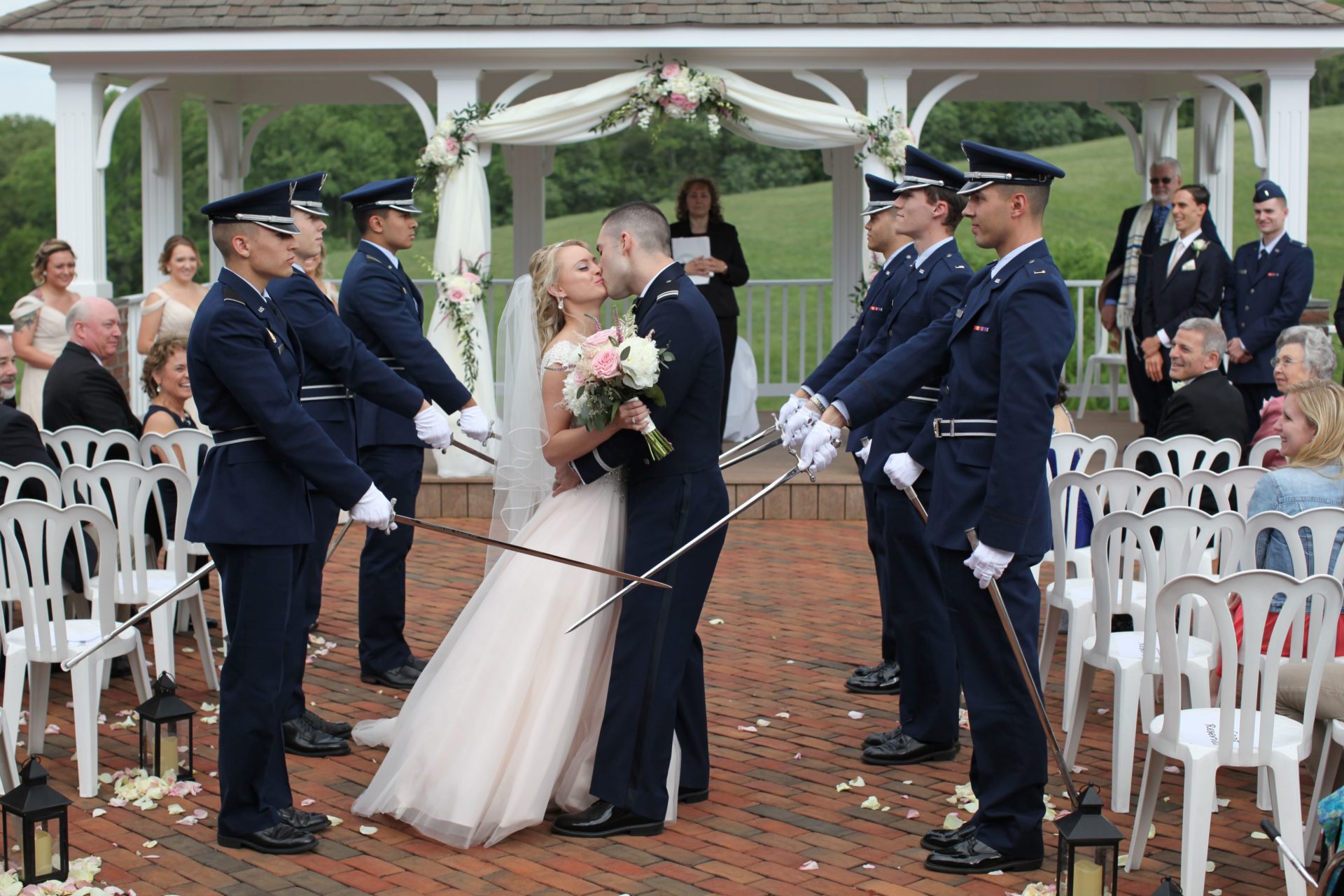 Bride and groom kiss after during military wedding at Morningside Inn
