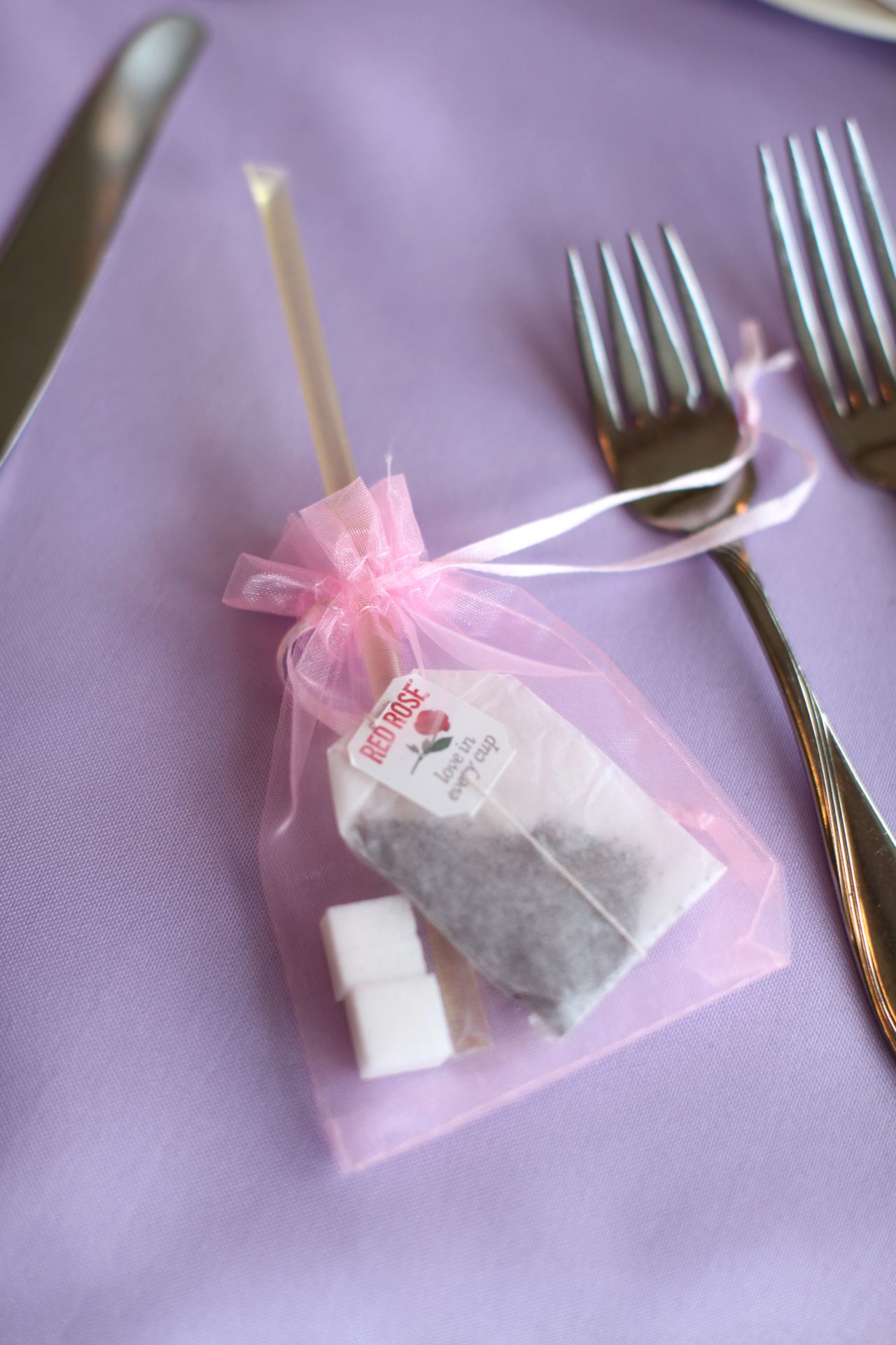 tea party theme wedding wedding favor of tea bag, sugar cubes, and honey stick
