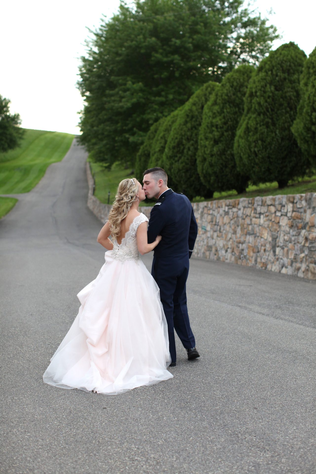 Bride and groom kiss in driveway of Morningside Inn wedding venue in Maryland
