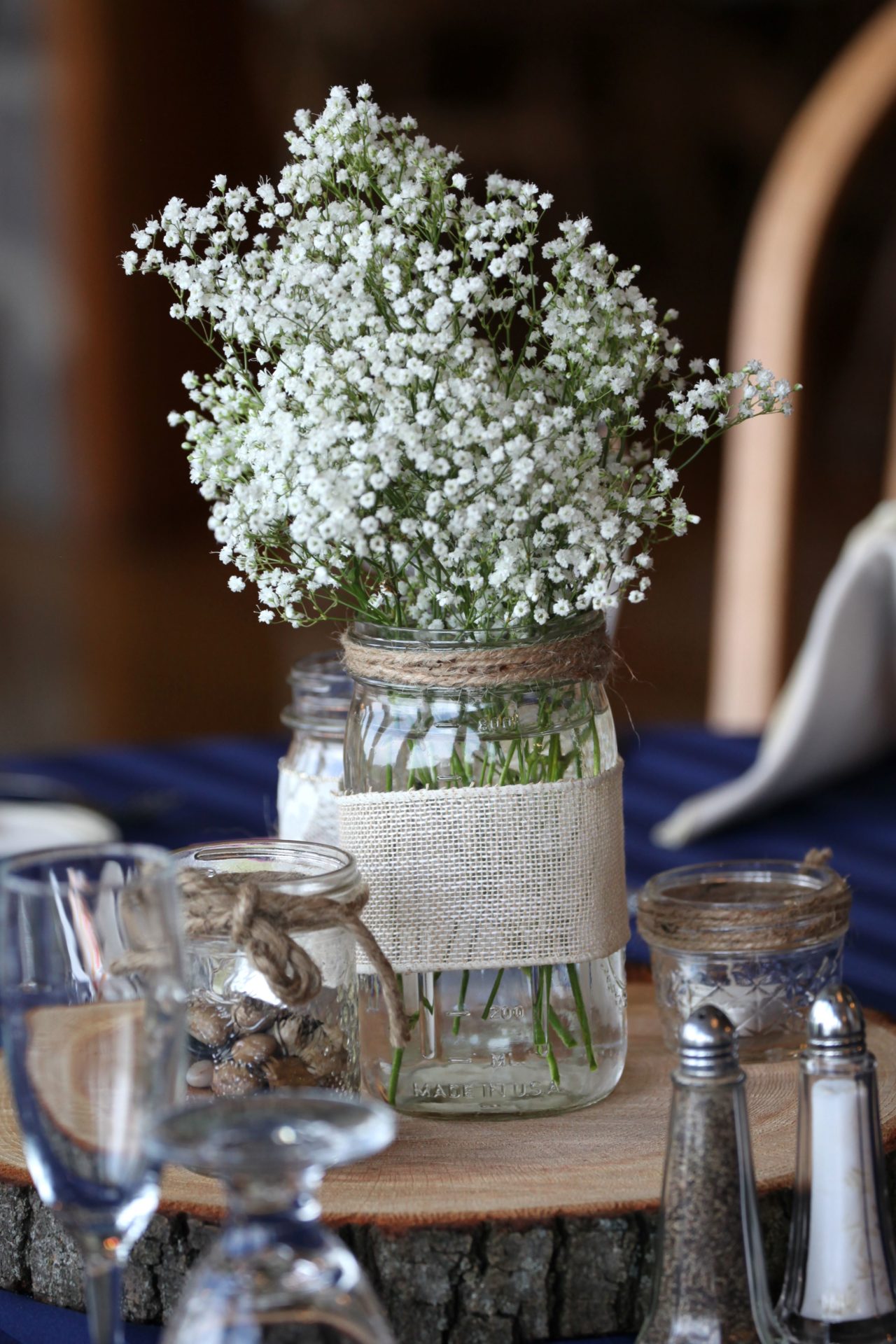 Rustic wedding centerpiece with jar and baby's breath flowers