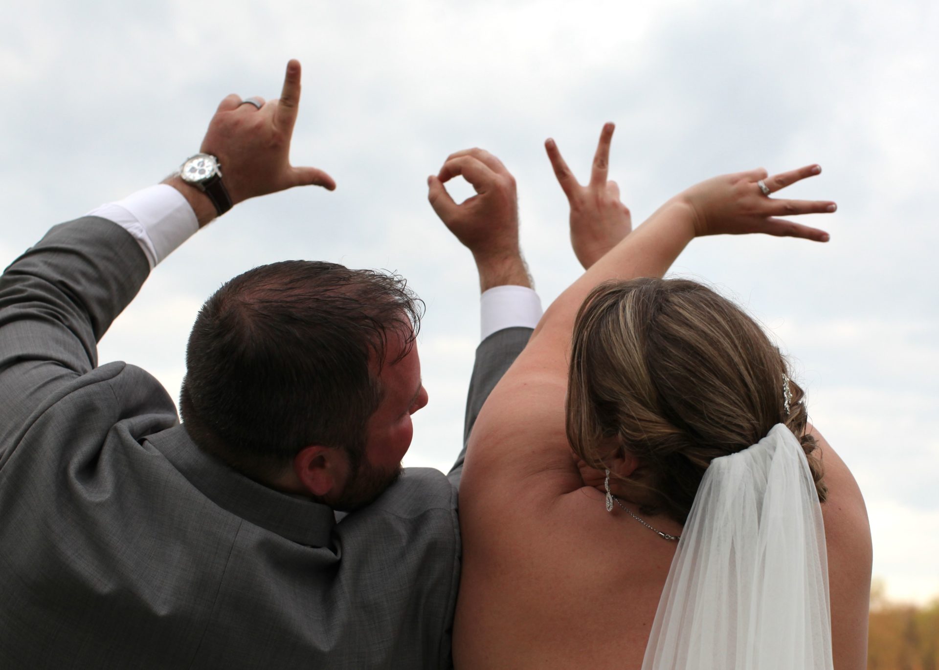 Bride and groom LOVE with hands
