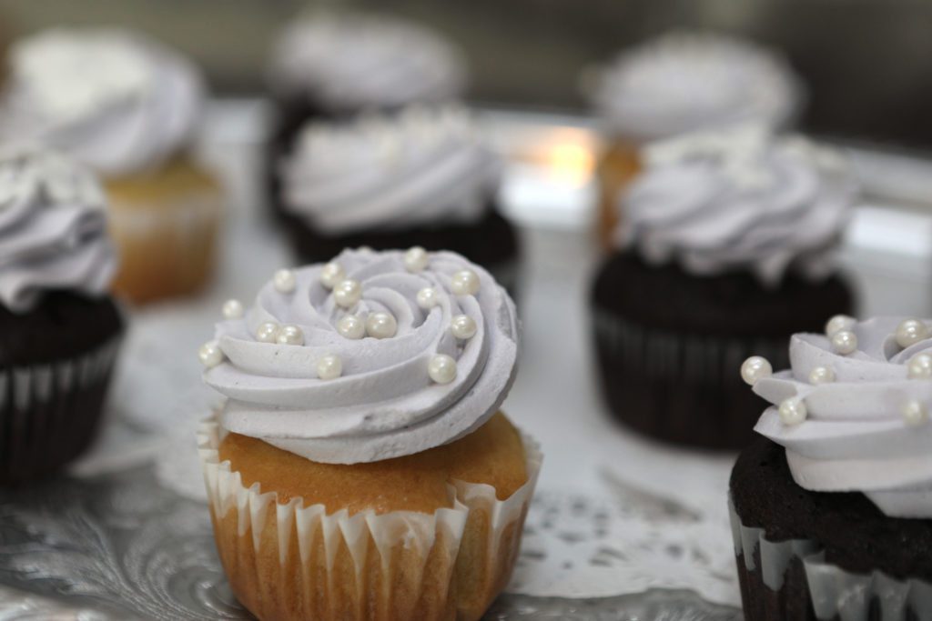 Wedding cupcakes with pearl sprinkles.