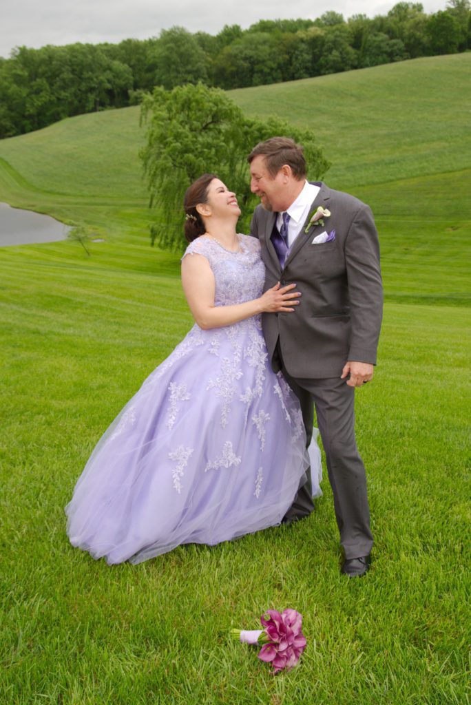 Bride and groom pose on back lawn of Morningside Inn